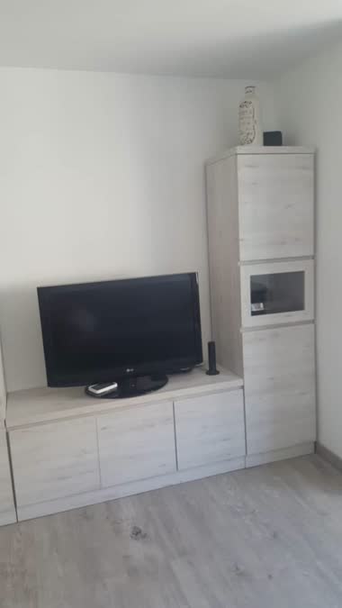 Comedor con televisor y muebles en blanco